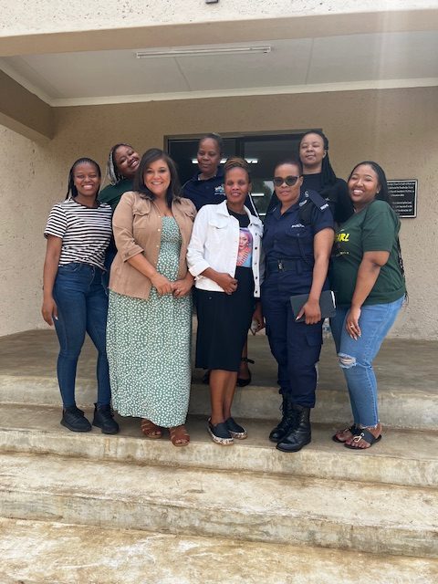 Group of ladies standing by steps taking a picture